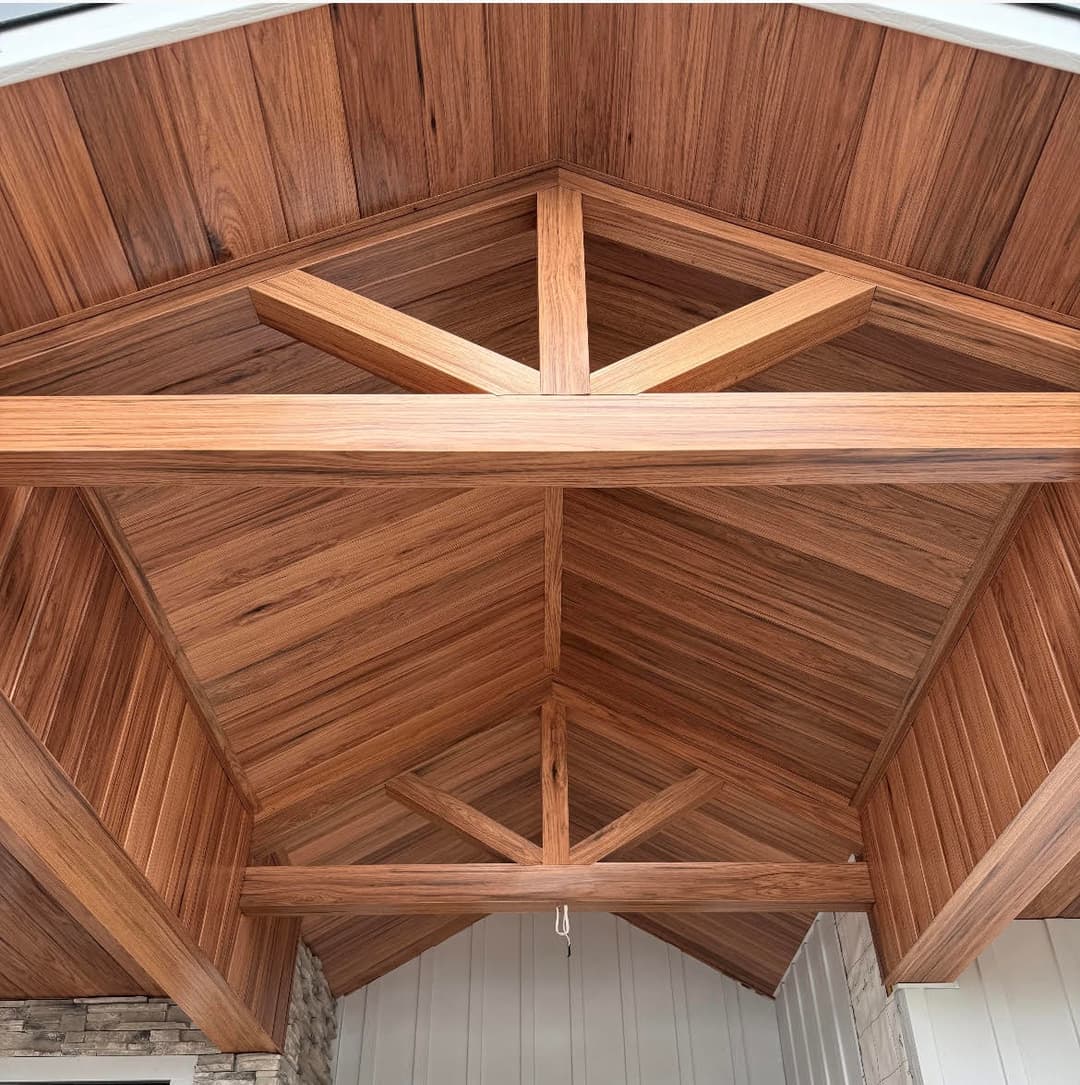 Wooden vaulted ceiling with decorative beams and warm-toned wood finishes.