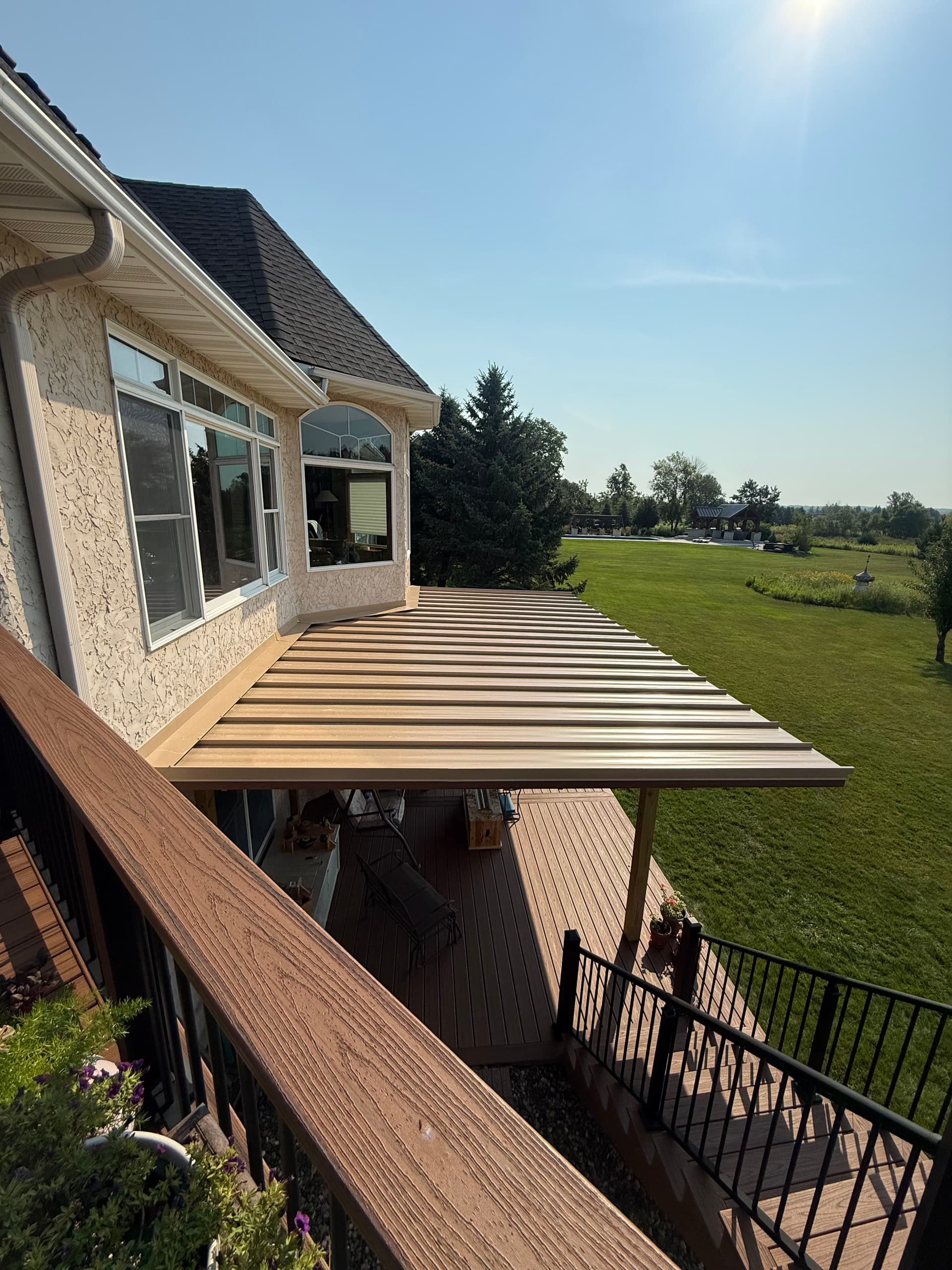 Low-Pitch Metal Roof Covers a Stunning Deck in Prior Lake image